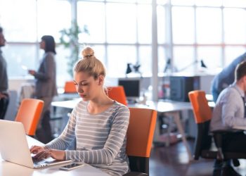 Different indivudals and groups working around the office of an startup incubator building
