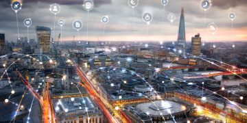 Skyline shot of London with lines running between buildings exampling an interconnecting professional network