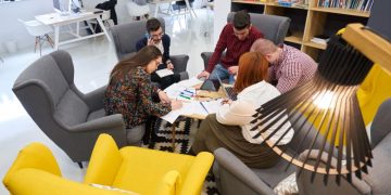 A team of entrepreneurs sitting around a table in a startup accelerator working on their project