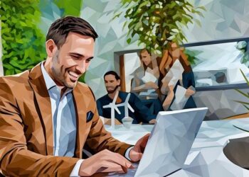 Entrepreneur sitting at his desk smiling because he is successful