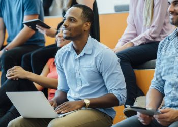A company giving a presentation in an auditorium to entice and entice the best information technology professionals and developers