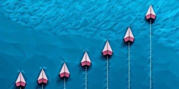 A series of paper lines flying above a blue ocean, with one in bright red symbolising the best exit strategy