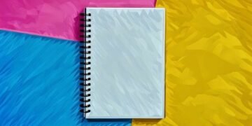 A blank notebook sitting on the bright coloured background, a place where you can write a new business name