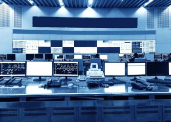 A series of monitors at desks , as an overblown example of how you could monitor and control customer credit