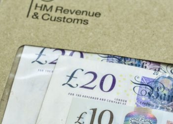 An envelope with British pounds in it being sent to the HMRC to pay a corporation tax bill