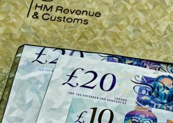 An envelope with British pounds in it being sent to the HMRC to pay a corporation tax bill