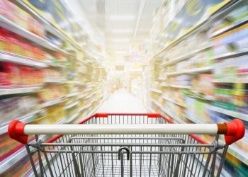 A supermarket trolley rushing through a supermarket showing all the products that have been sold into the supermarket