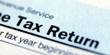 Tax return close up with a marked deadline looming for when tax fees are due