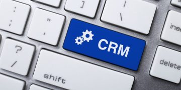 A key on a keyboard saying CRM and highlighted blue