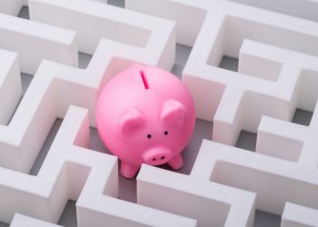 A piggy bank in the middle of a maze showing how difficult it can be to find funding for your business
