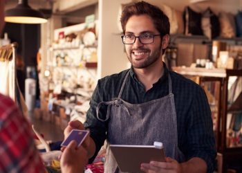 Entrepreneur interacting with a customer at his shop