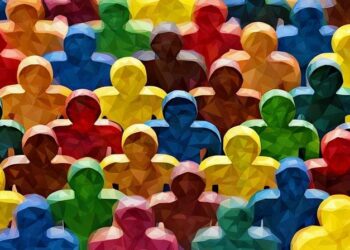 A series of coloured wooden people outlines , made up of many different colours symbolising different cultures