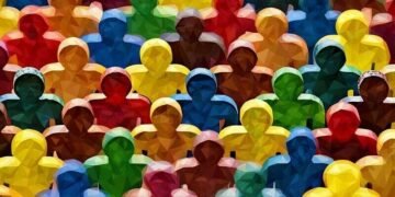 A series of coloured wooden people outlines , made up of many different colours symbolising different cultures