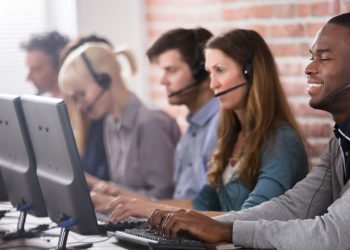 A team of customer service representatives working together answering customer calls via telephone