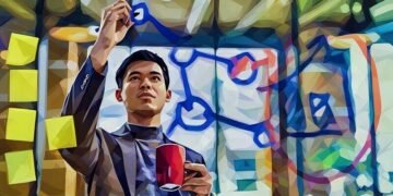 Chinese entrepreneur writing on a whiteboard in an accelerator