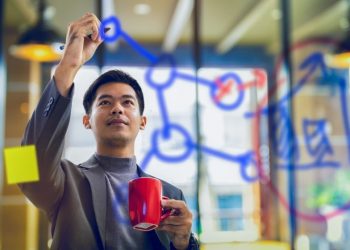 Chinese entrepreneur writing on a whiteboard in an accelerator
