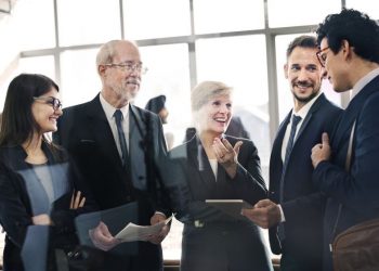 A group of conference goers networking and building social capital to easily access decision makers in each others organisations