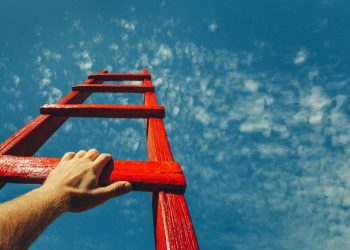 A mans hand grabbing the next rung of a ladder to nowhere as a metaphor for trying to understand his motivational drivers