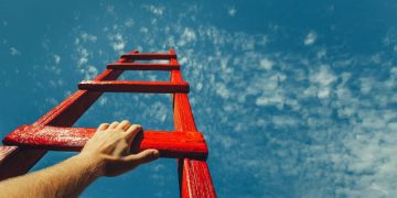 A mans hand grabbing the next rung of a ladder to nowhere as a metaphor for trying to understand his motivational drivers