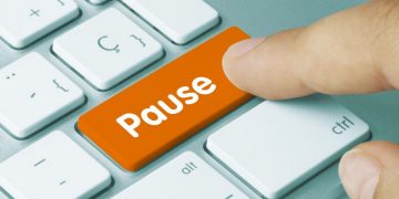 Pause button representing stopping and thinking about how to make the office stress free