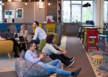 Two colleagues playing computer games at work as an example of how playing at work can be productive