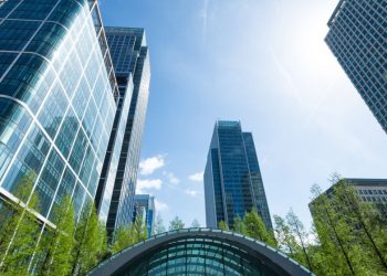 A series of office buildings as you exit Canary wharf station on a sunny day and look back, where the majority of UK private equity funds are based