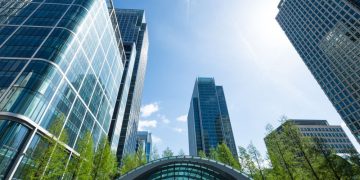 A series of office buildings as you exit Canary wharf station on a sunny day and look back, where the majority of UK private equity funds are based