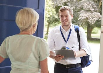 A women opens her door and begins to answer survey questions