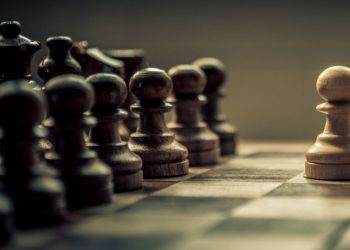 Chess piece moved strategically on a chess board as a metaphor for strategic management in a business context