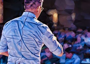 Speaker talking about marketing and innovation in front of a crowd at a Ted event