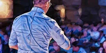 Speaker talking about marketing and innovation in front of a crowd at a Ted event