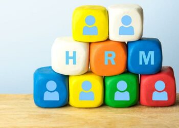 Human Resources Management in between dice with pictures of tiny office workers on them