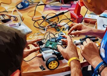 Two men constructing a robotic toy car using a raspberry Pi micro computer