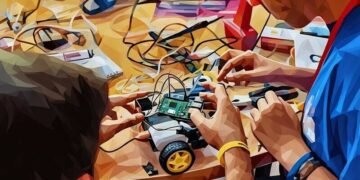 Two men constructing a robotic toy car using a raspberry Pi micro computer