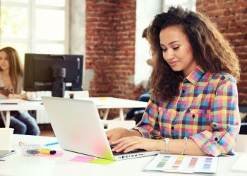 A blogger writing at her laptop after receiving a great outreach email