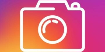 Instagram symbol of a camera outline on he purple and orange brand background