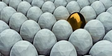 Golden egg in white eggs representing a valuable business