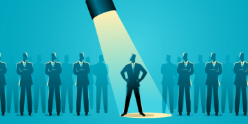 A torch shining down on a single potential founder out of many