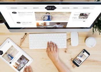 Blogger using her apple computer to write and publish a new blog post