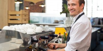 Small business owner whose happy to have received financing for his new cafe business