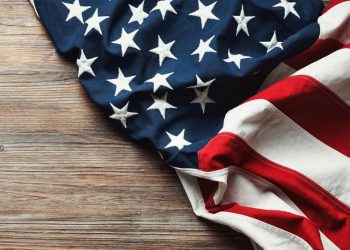 An american flag on a work desk, as an example of american culture in the workplace