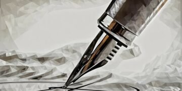 Closeup of a fountain pen writing on paper, showing how someone can improve their writing skills