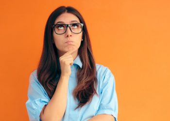A women with glasses making a decision about whether to remain an employee or become an entrepreneur