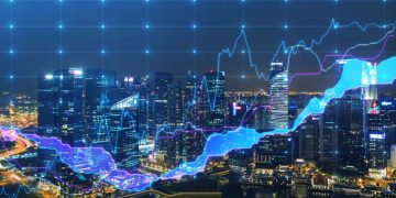 A graph of the financial markets, plotting financial data with a city at nighttime in the background