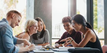 Students at a table discussing what businesses they can start together