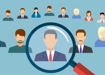 A magnifying glass over a job candidate signalling one of the ways to find and attract employees