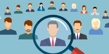 A magnifying glass over a job candidate signalling one of the ways to find and attract employees
