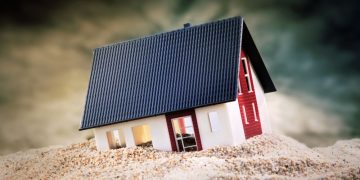 A house sinking into sand exampling how if you build bad foundations for a business it will fail