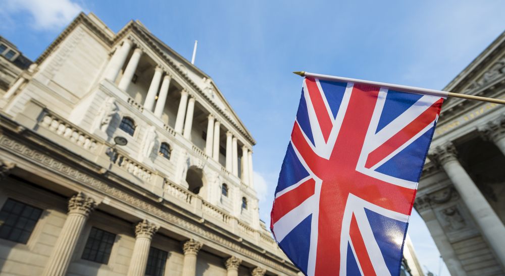 A union jack flag flying over the bank of England in the financial district on London, exampling where businesses can get financing