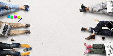 Employees lying down on the floor in a relaxed way with work material around them symbolising a poor work ethic